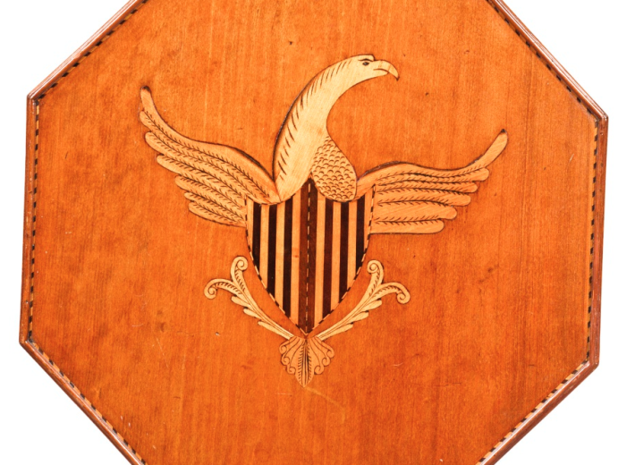 Eagle marquetry on a tea table in an auction selling American Federal furniture