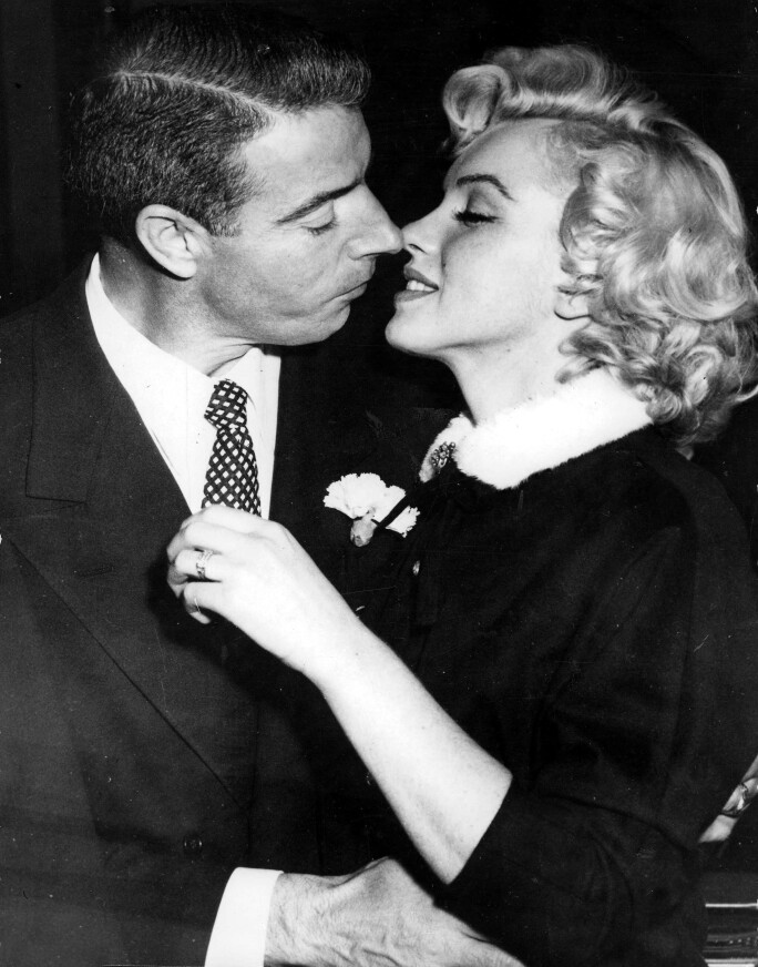 Marilyn Monroe and Joe DiMaggio kiss after their wedding, 1954.