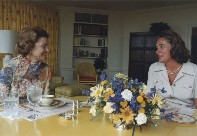 First Lady Betty Ford and Happy Rockefeller talk in the White House Solarium embrace.