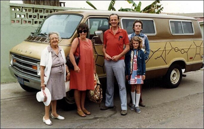 Scientist Richard Feynman's family poses in front of his famous van, decorated with his particle diagrams.