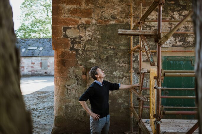 Hugh Burge with scaffolding outside Marchmont House