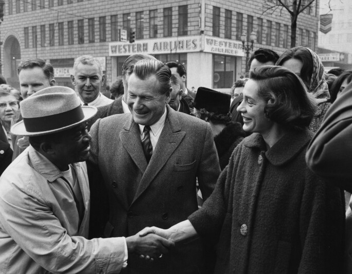 Happy Rockefeller shaking a man's hand
