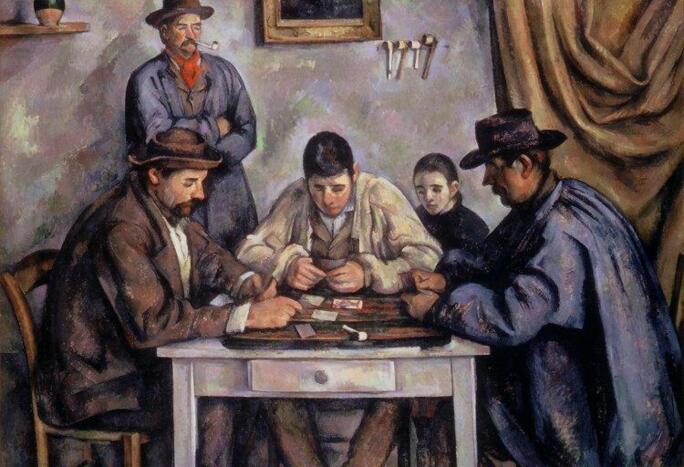 Three men sitting at a table playing cards with a man and boy in the background