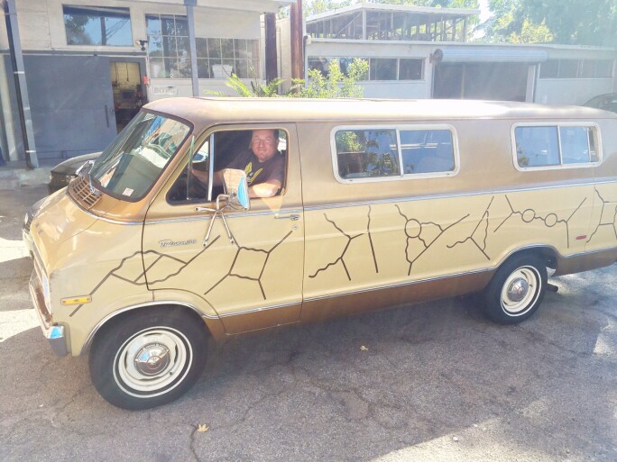 Seamus Blackey with the restored Feynman van, painted with Feynman's iconic particle diagrams.
