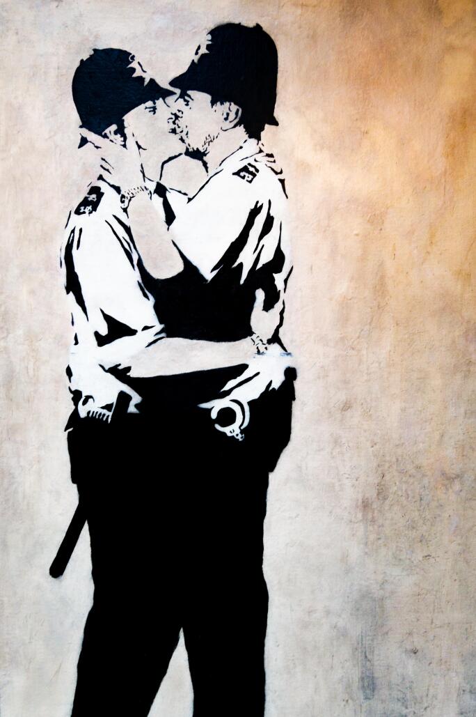 Banksy's work Kissing Coppers shows two UK police officers kissing.