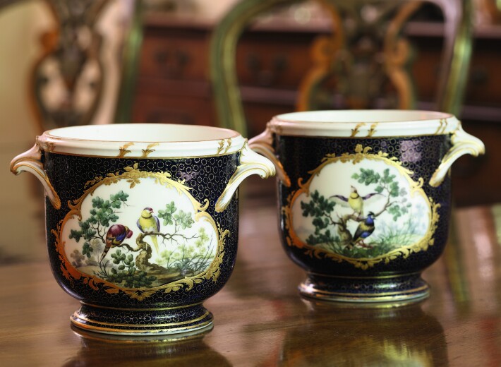Pair of Sèvres vases with gilding and flowers in an auction selling Sèvres porcelain