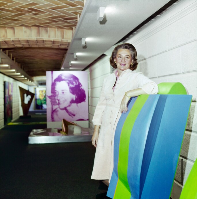 Happy Rockefeller standing with art