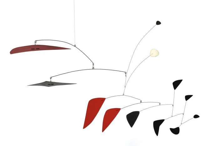 A mobile with red, black a one white geometric shapes.
