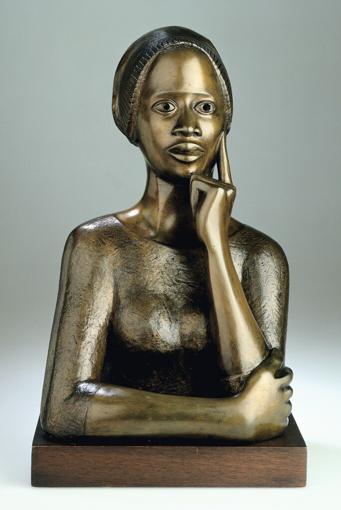 Sculpture of a woman with her face resting on her hand.
